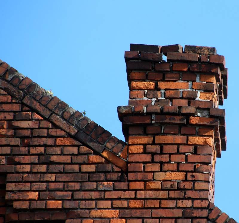 Damaged chimney on an Chelsea home showing cracks and missing mortar